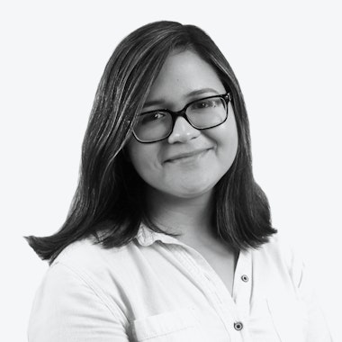 a black and white photo of a woman wearing glasses